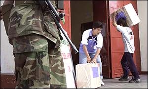 Ballot boxes being collected and counted under guard