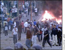 Youths rioting in the streets of T'jomapai in the country's centre